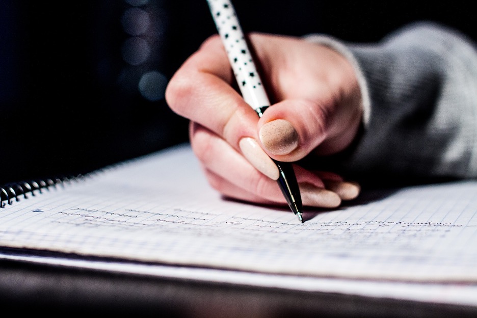 close-up of a hand on a notebook