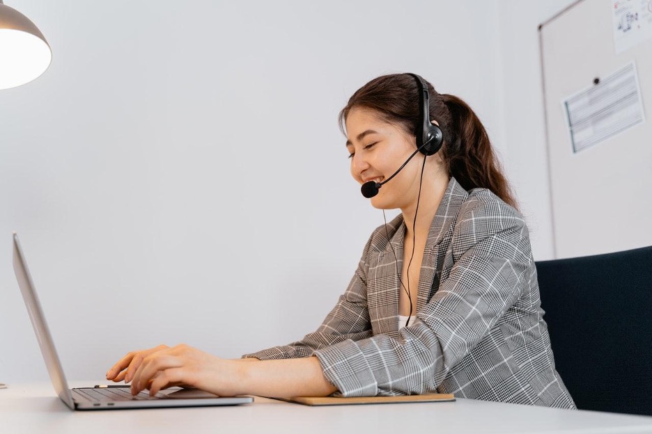 a female employee typing on a laptop