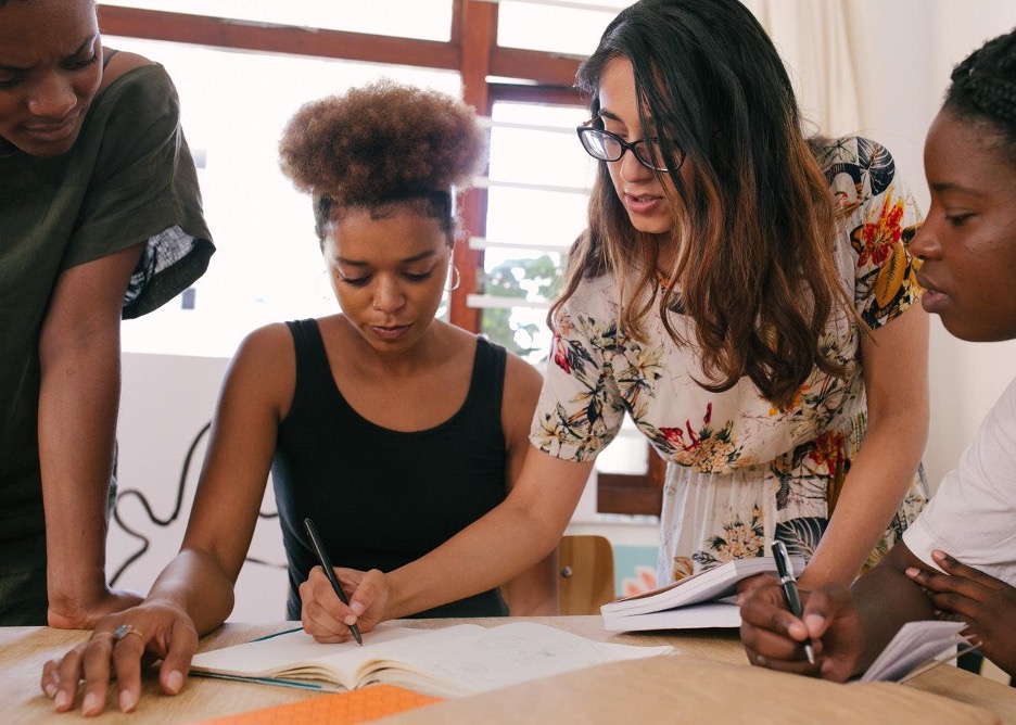 Female Employees Work Together on a Business Proposal