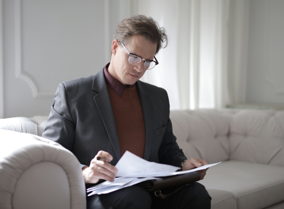 a lawyer reviewing documents on the couch