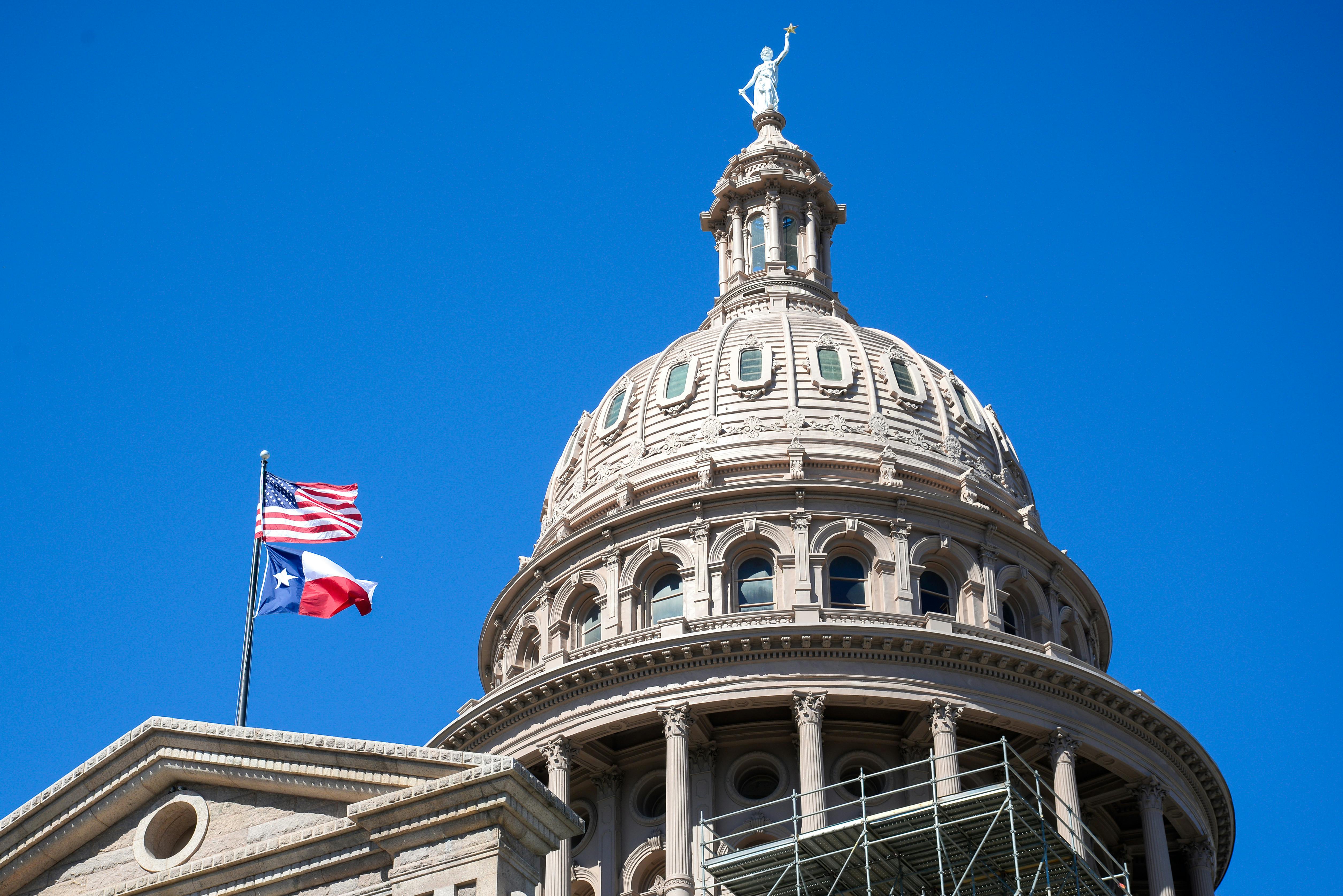 Rotunda on an old building with two flags flying outside