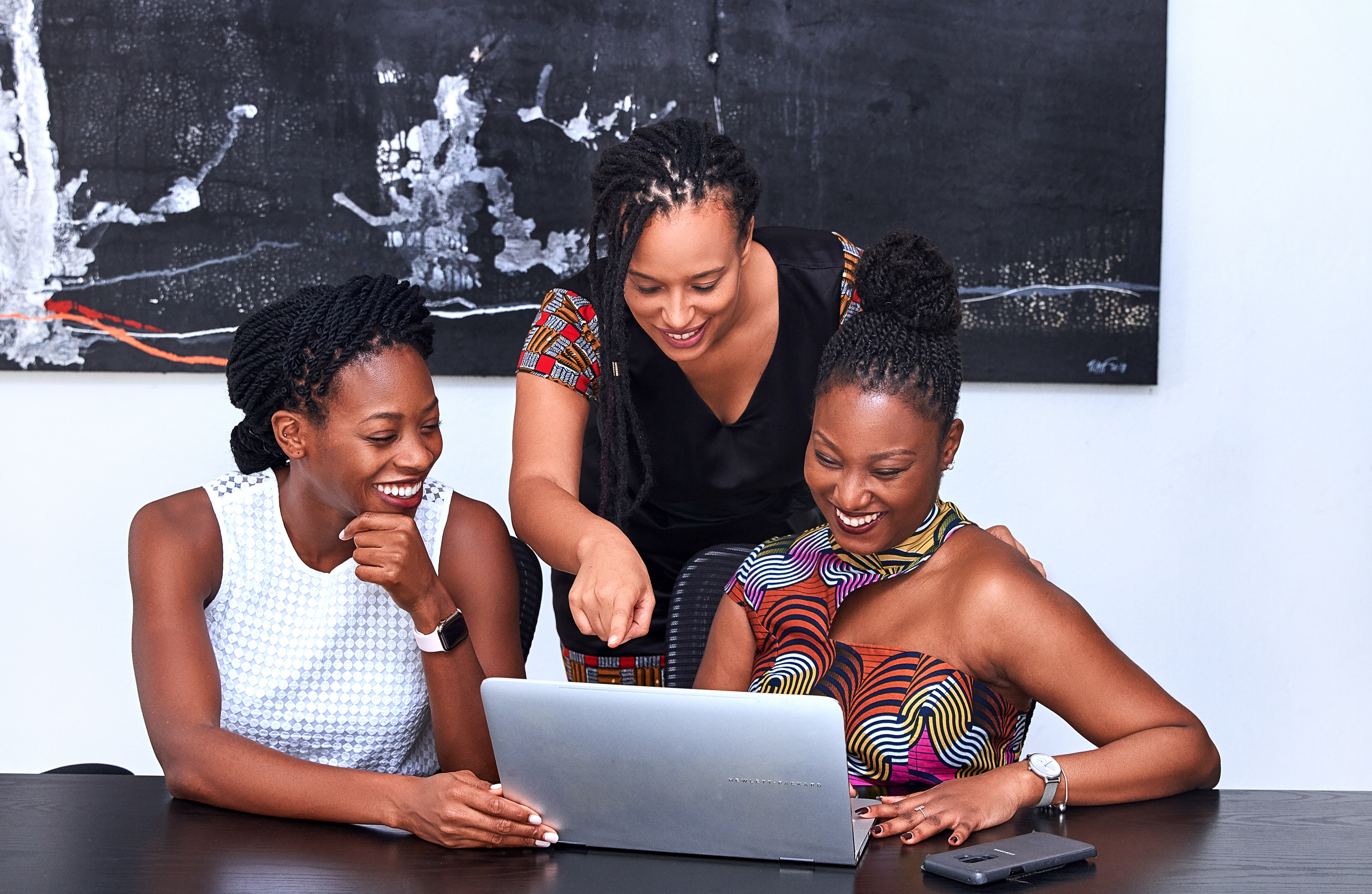 3 feminine employees working on a business proposal